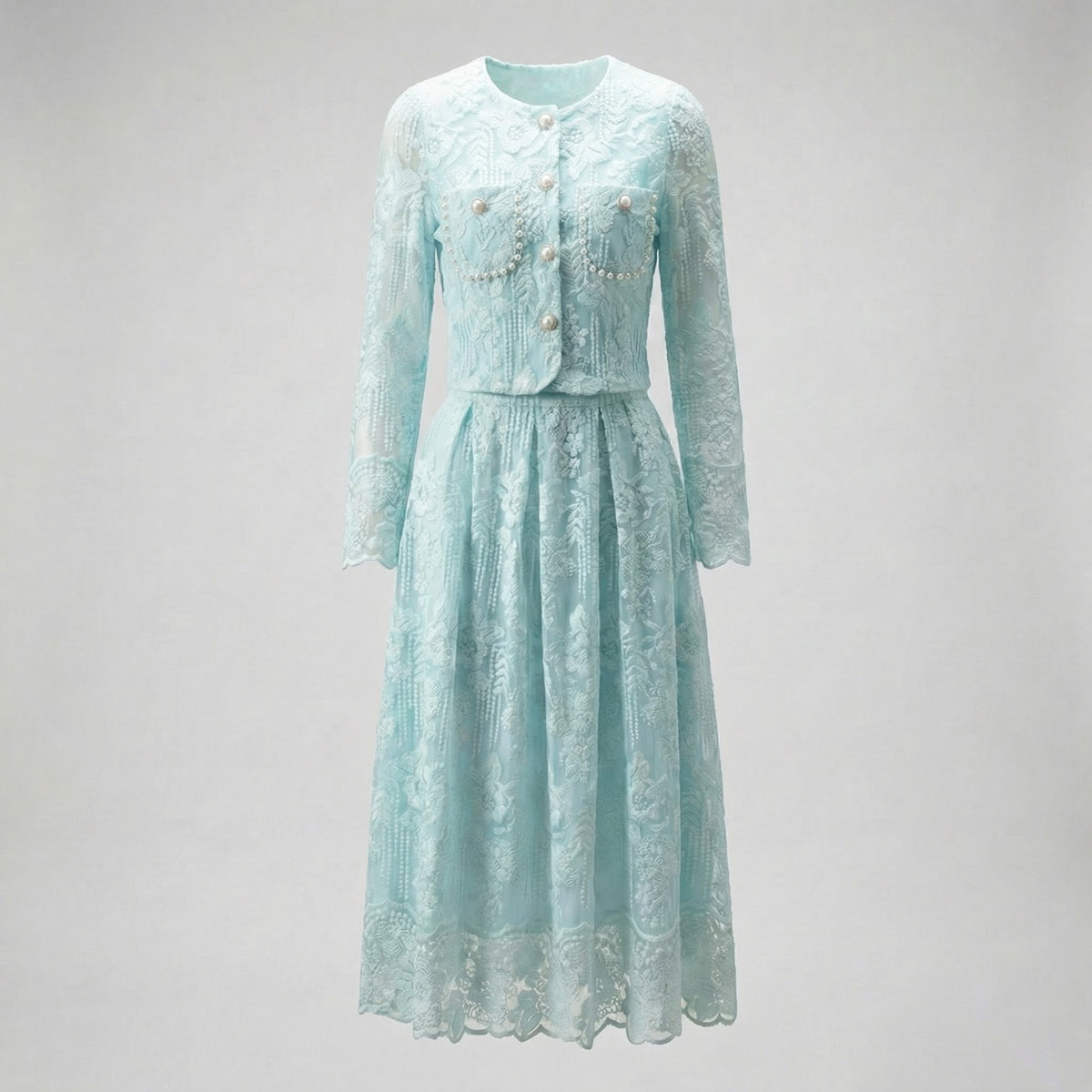 Thelma two-piece set featuring a pink floral lace cropped jacket with large pearl buttons and a matching 75cm midi skirt.