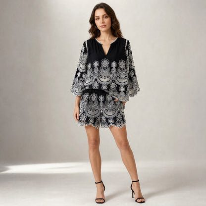 Antonia matching lace outfit in classic black with contrasting white eyelet embroidery, featuring the flowing bell sleeve top and high-waisted casual summer shorts. Antonia set shorts, showcasing the comfortable elastic waistband and intricate scalloped embroidery.delicate V-neckline, vertical pleats, and intricate floral eyelet lace cutout detailing on the fabric.