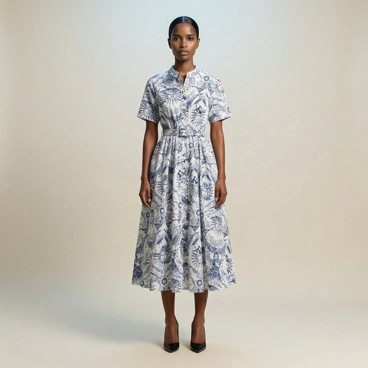 The Veronica midi dress featuring a short-sleeved ribbed knit bodice and a side-pleated accordion skirt with a matching waist belt.