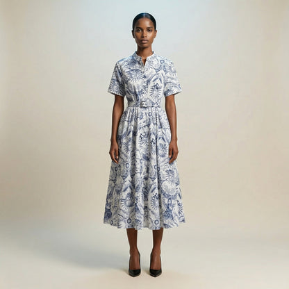 The Veronica midi dress featuring a short-sleeved ribbed knit bodice and a side-pleated accordion skirt with a matching waist belt.