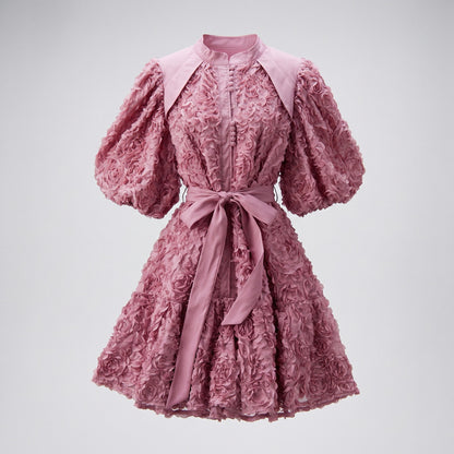 Zoe 3D rosette textured mini dress with puff sleeves and waist tie, 95cm length, available in black, pink, purple, wine, and cream.